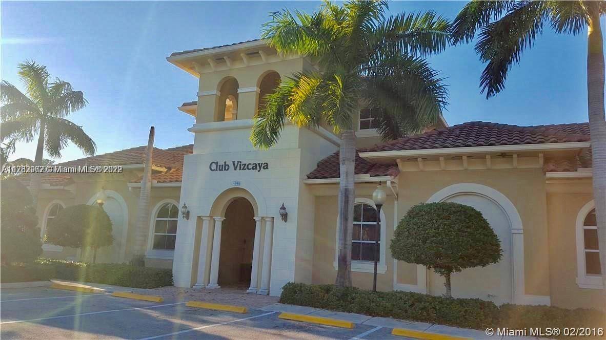 14055 Southwest 49th Street, Unit 6 Miramar, FL 33027 - Photo 10 of 12 a front view of a house with yard and parking