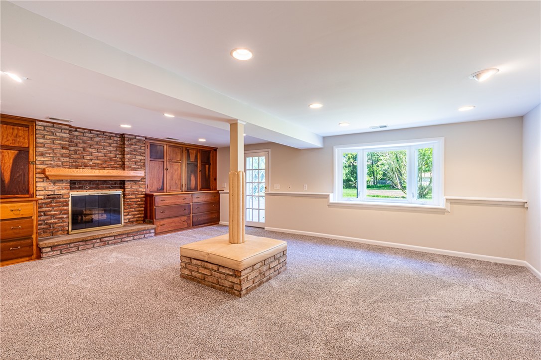 274 Parkview Drive Rochester, NY 14625 - Photo 16 of 41 Spacious family room with walk out, gas fireplace and beautiful wooden built in and brand new carpet.