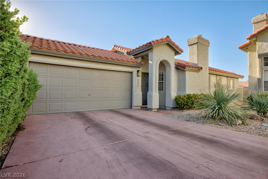 2254 Ramsgate Drive Henderson, NV 89074 - Photo 3 of 43 A terracotta-tiled roof and stucco exterior greet visitors, complemented by desert-friendly landscaping.