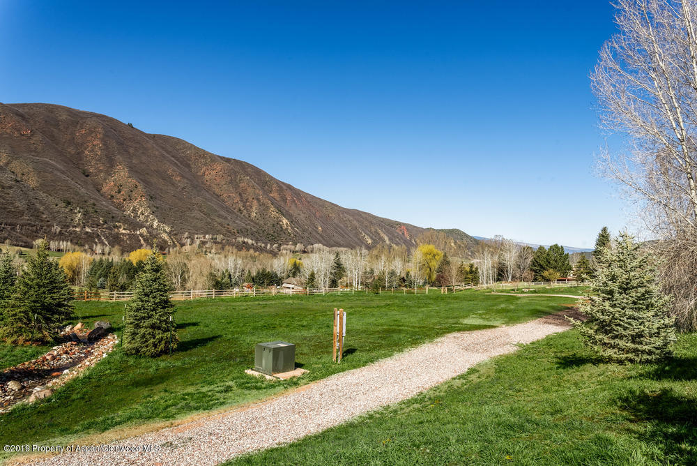 182 Hoaglund Ranch Road Basalt, CO 81621 - Photo 15 of 31 a view of a grassy field with mountains in the background