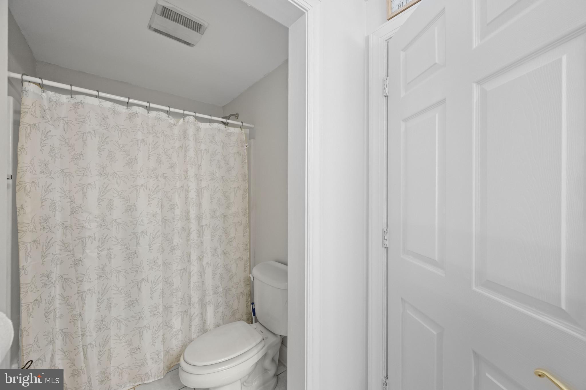 194 Cook Road Delta, PA 17314 - Photo 30 of 35 a white toilet sitting next to a shower curtain