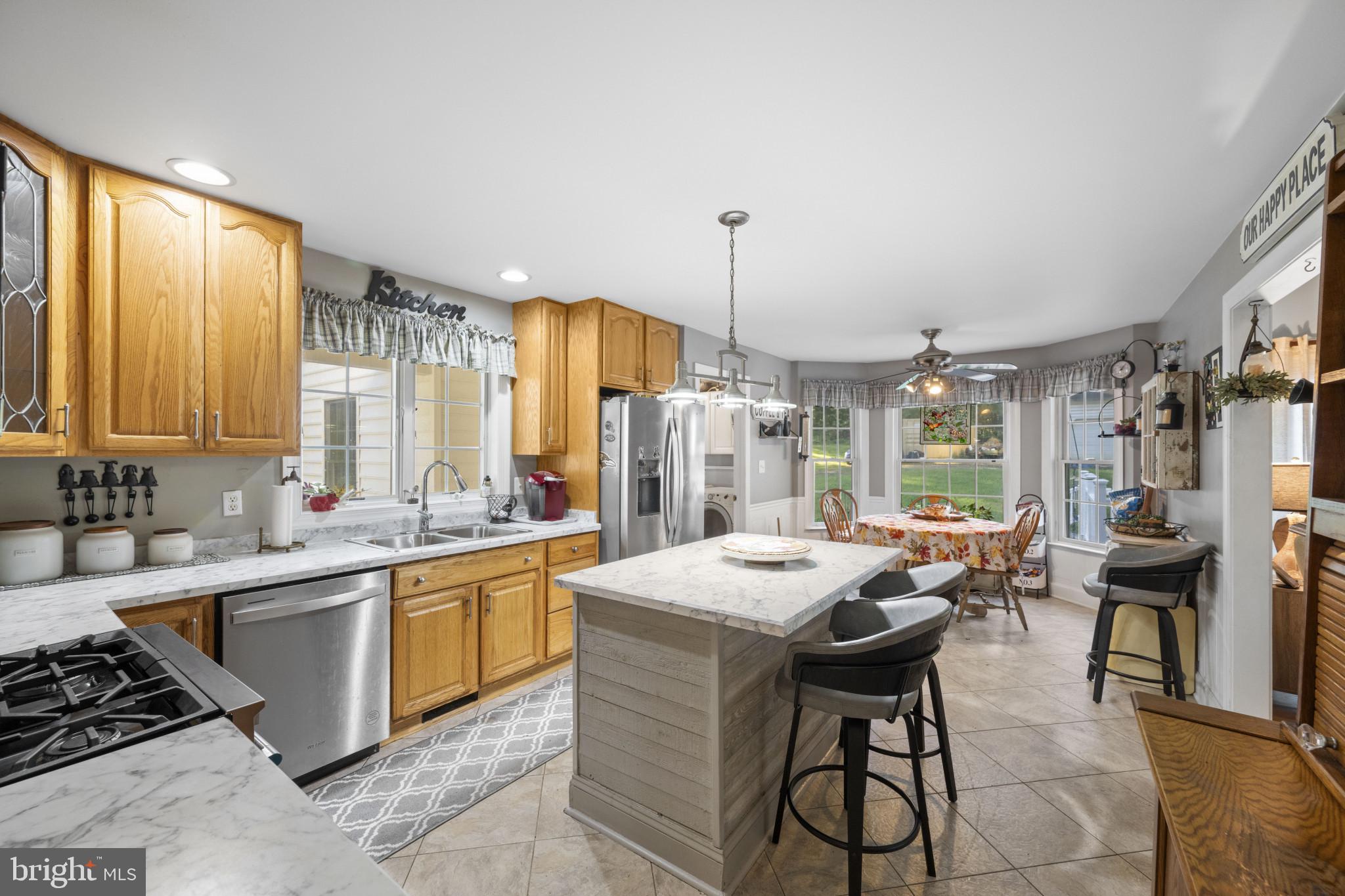 194 Cook Road Delta, PA 17314 - Photo 3 of 35 a kitchen with a sink stove and chairs