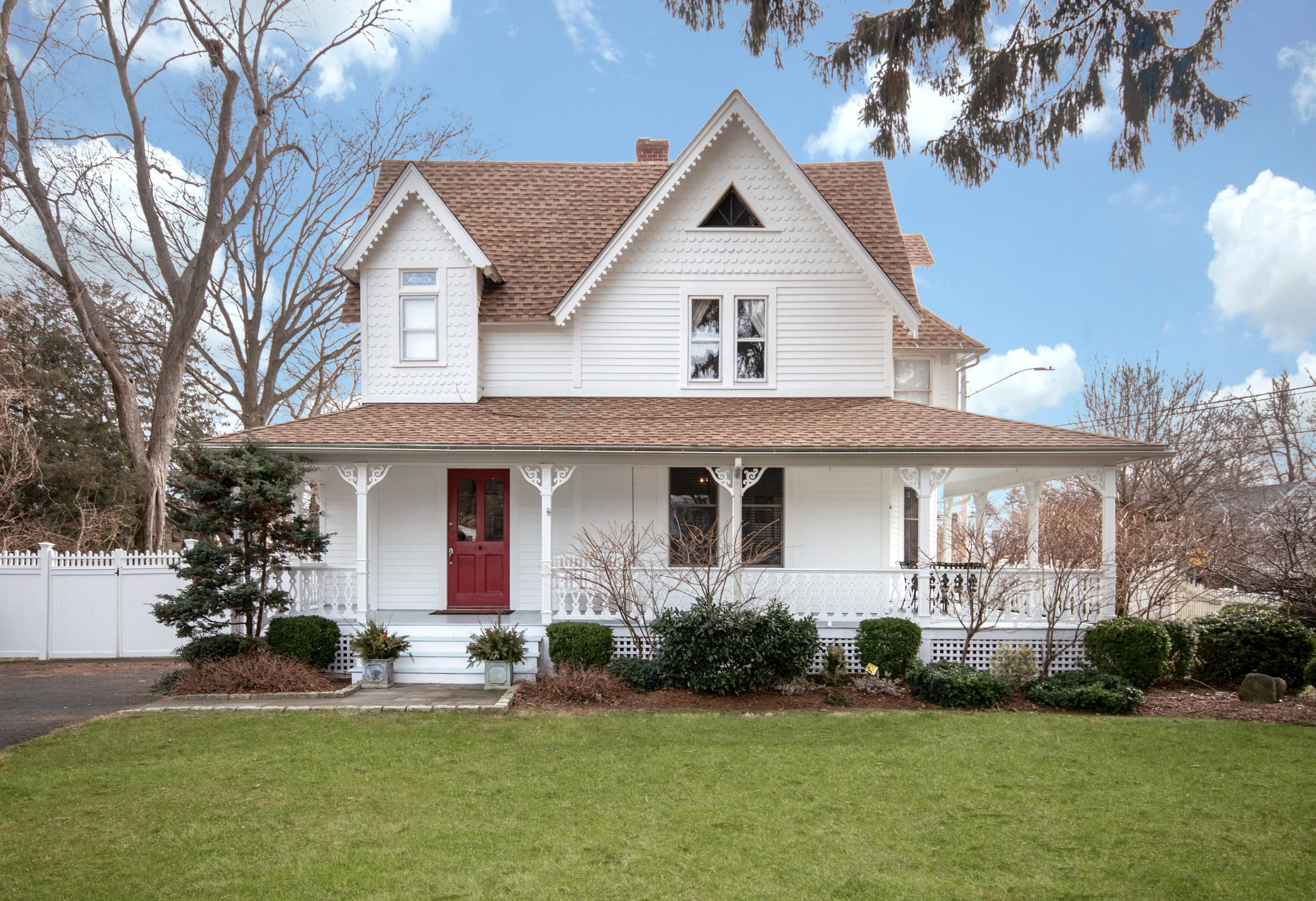 338 Flax Hill Road Norwalk, CT 06854 - Photo 1 of 26 a front view of a house with a yard and garage