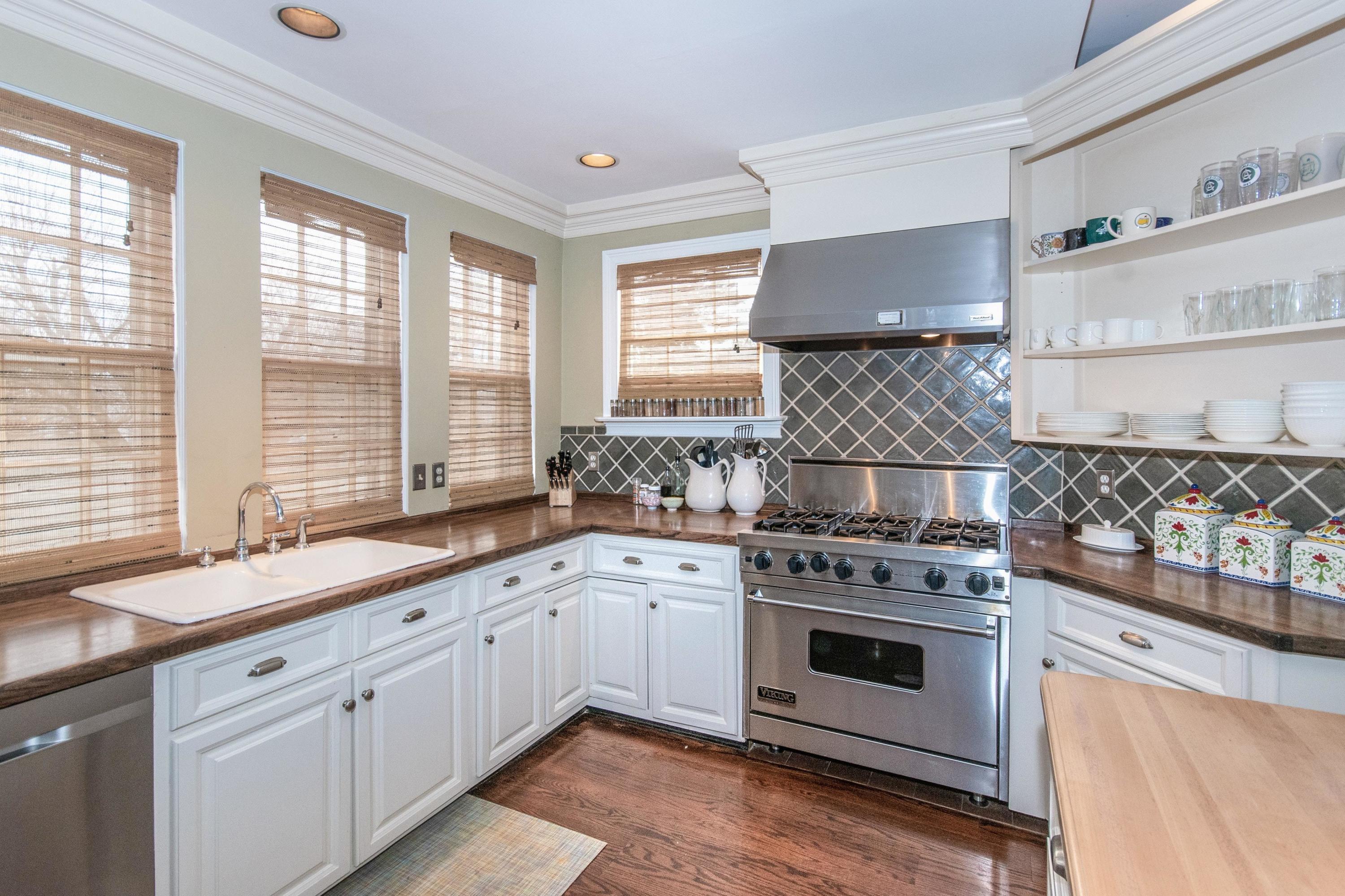 338 Flax Hill Road Norwalk, CT 06854 - Photo 11 of 26 a kitchen with stainless steel appliances a stove sink and cabinets