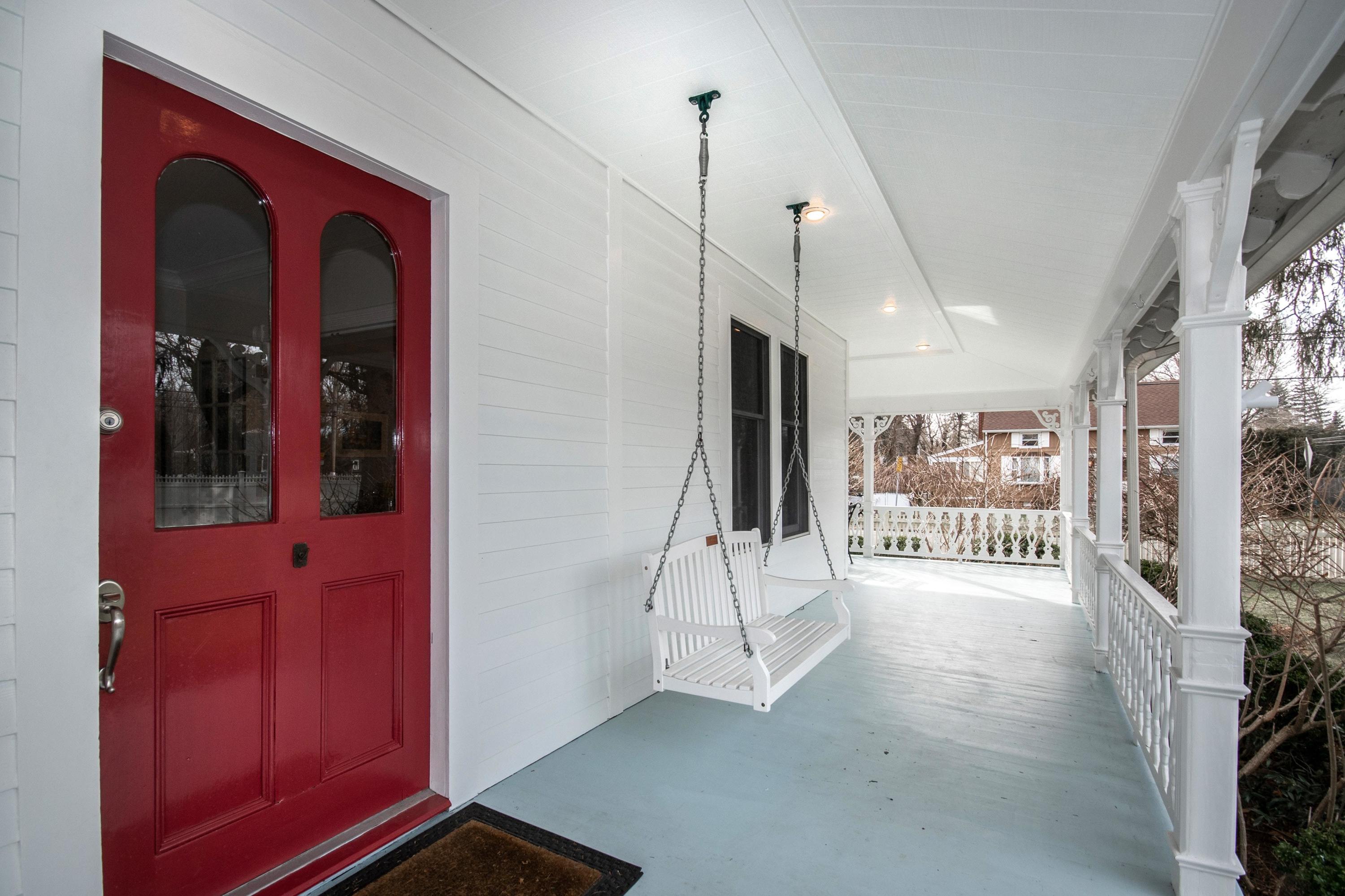 338 Flax Hill Road Norwalk, CT 06854 - Photo 3 of 26 a view of a hallway with a red door and furniture
