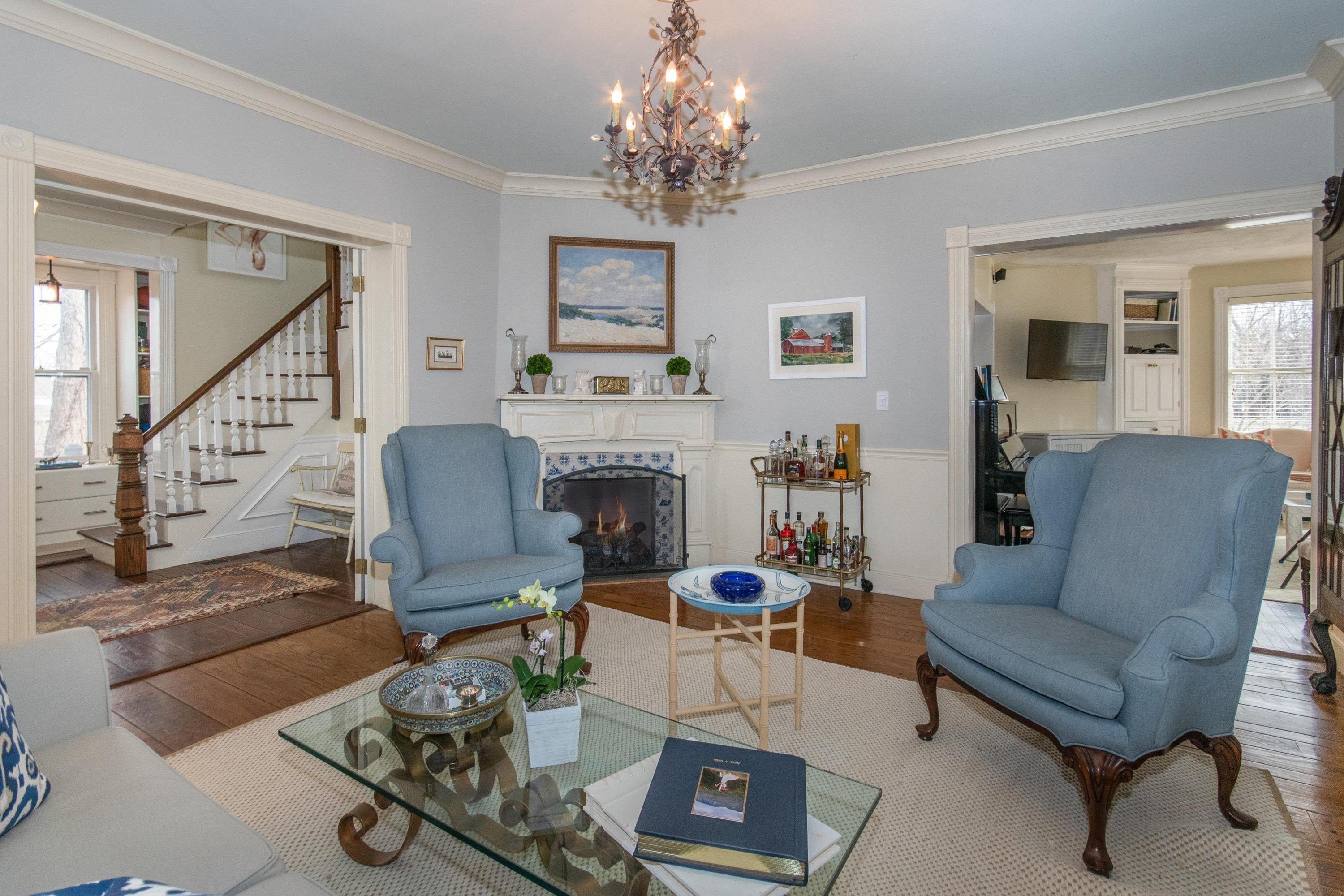 338 Flax Hill Road Norwalk, CT 06854 - Photo 6 of 26 a living room with furniture a fireplace and a chandelier