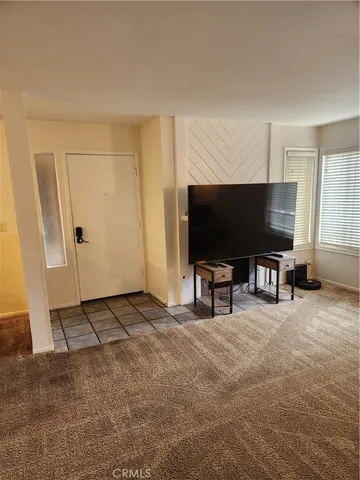 a living room with projector and a flat screen tv