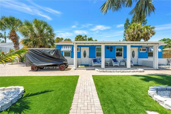a front view of house with yard and outdoor seating