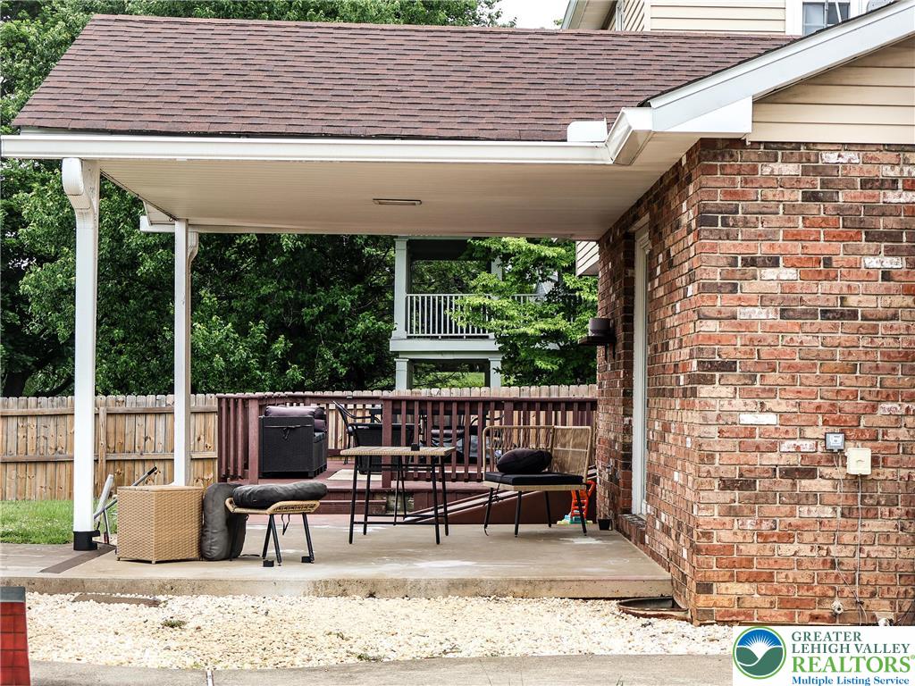 10 Dusty Road Easton, PA 18045 - Photo 10 of 35 An inviting covered patio adjoins a spacious wooden deck, perfect for outdoor enjoyment.