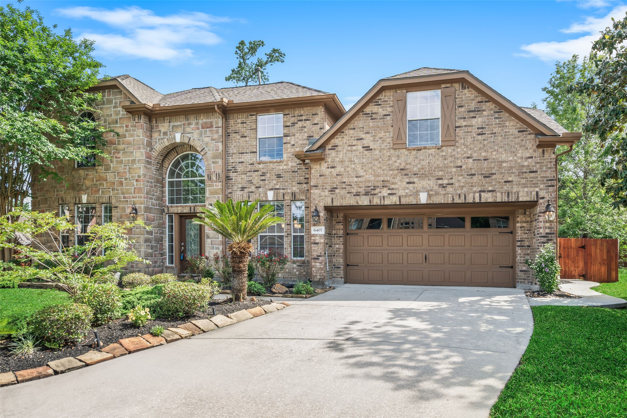 6407 Ashley Manor Drive Spring, TX 77389 - Photo 2 of 41 a front view of a house with garden