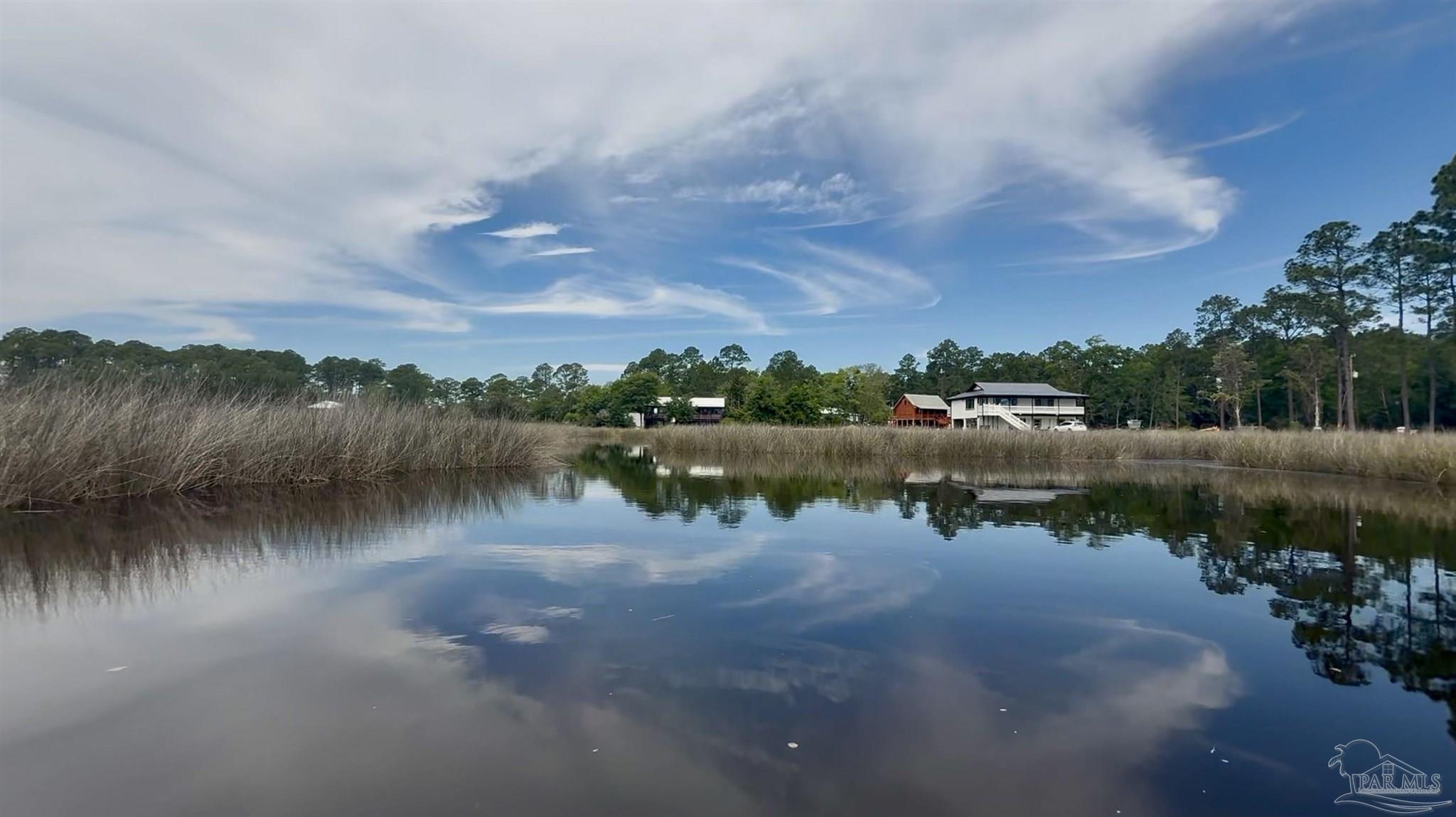 7524 Petersen Point Road Milton, FL 32583 - Photo 4 of 26 a view of a lake with houses in the back