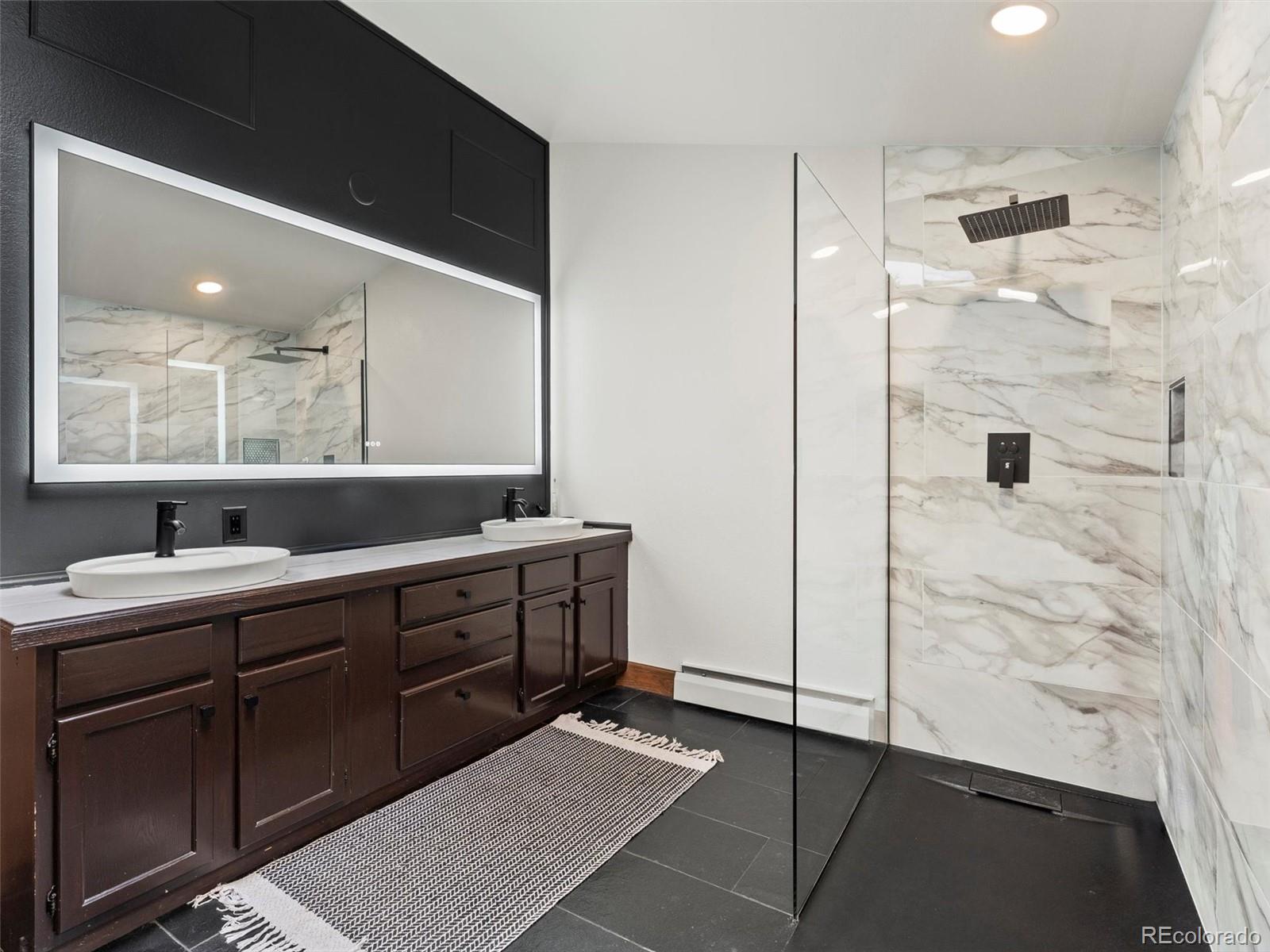 9459 South Turkey Creek Road Morrison, CO 80465 - Photo 15 of 25 a spacious bathroom with a shower and a sink