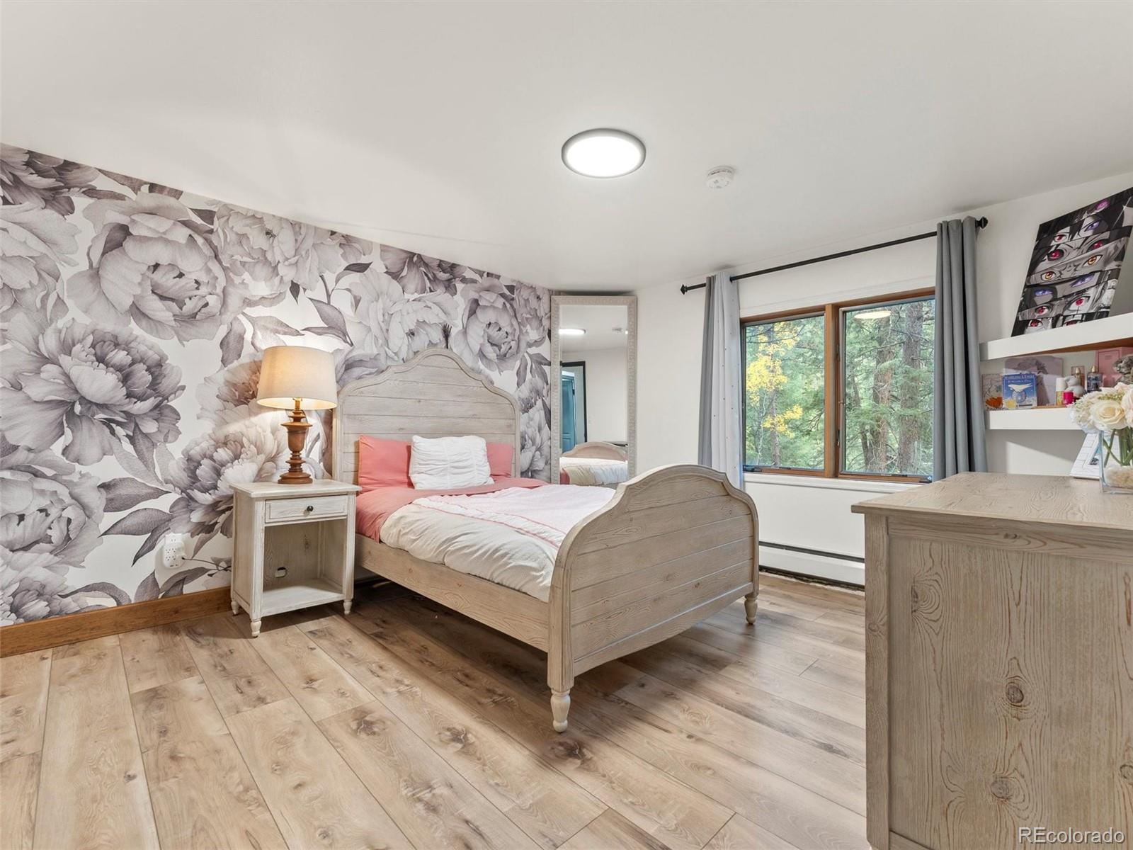 9459 South Turkey Creek Road Morrison, CO 80465 - Photo 17 of 25 a bedroom with a large bed and a window