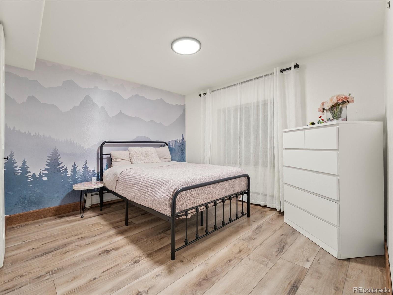 9459 South Turkey Creek Road Morrison, CO 80465 - Photo 18 of 25 a bedroom with a bed and cabinet