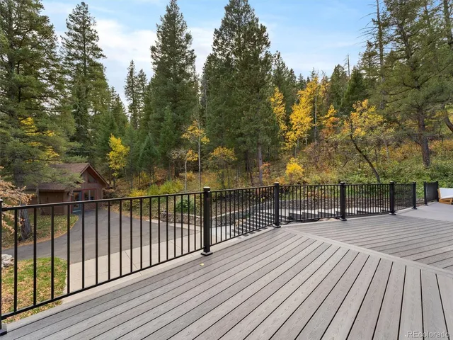 a view of a wooden deck with trees