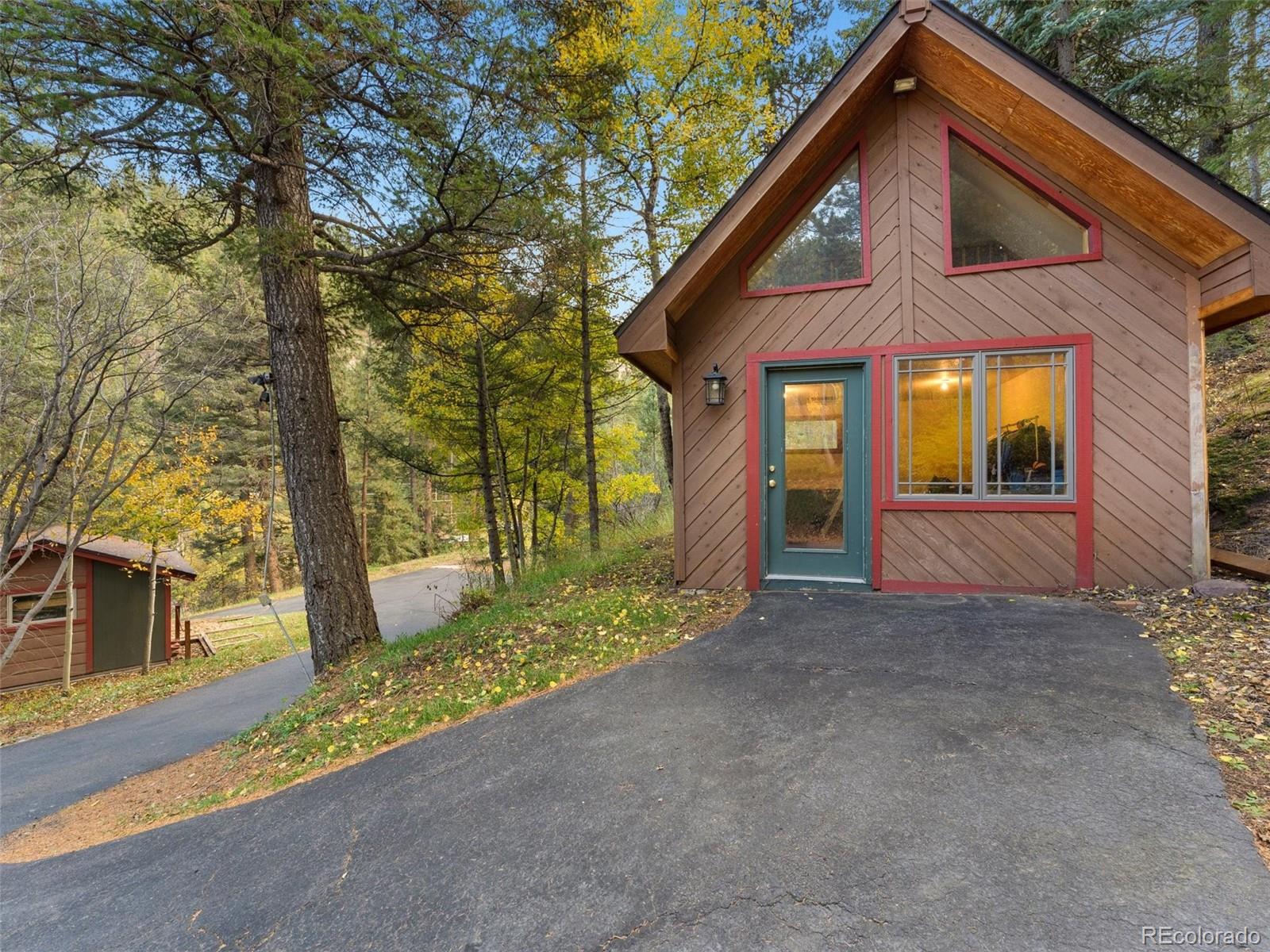 9459 South Turkey Creek Road Morrison, CO 80465 - Photo 21 of 25 a view of a house with a yard