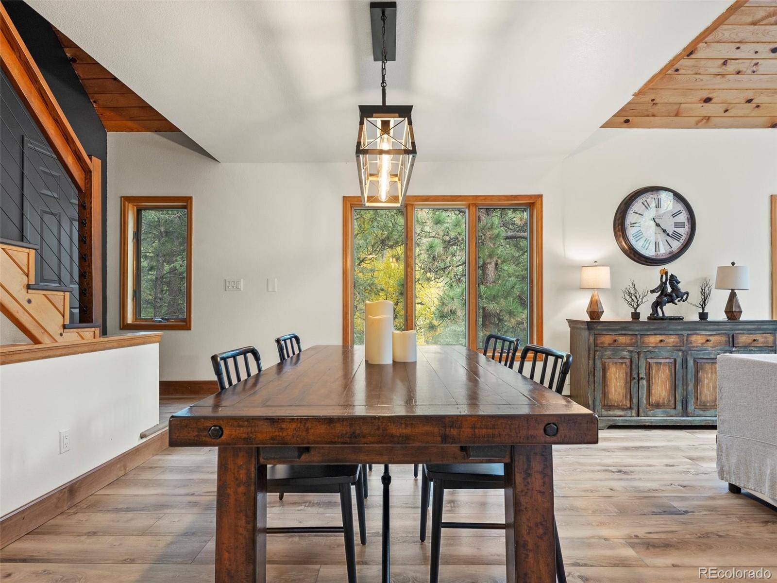 9459 South Turkey Creek Road Morrison, CO 80465 - Photo 7 of 25 a view of a dining room with furniture window and wooden floor