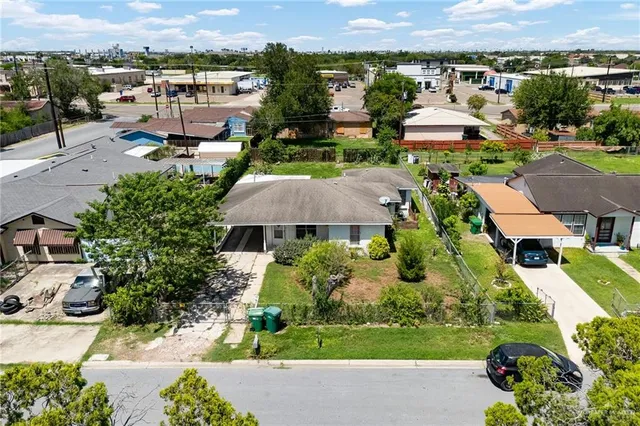 an aerial view of a house with yard swimming pool and outdoor seating
