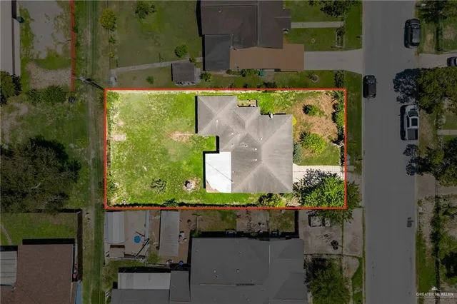 an aerial view of a house with a yard