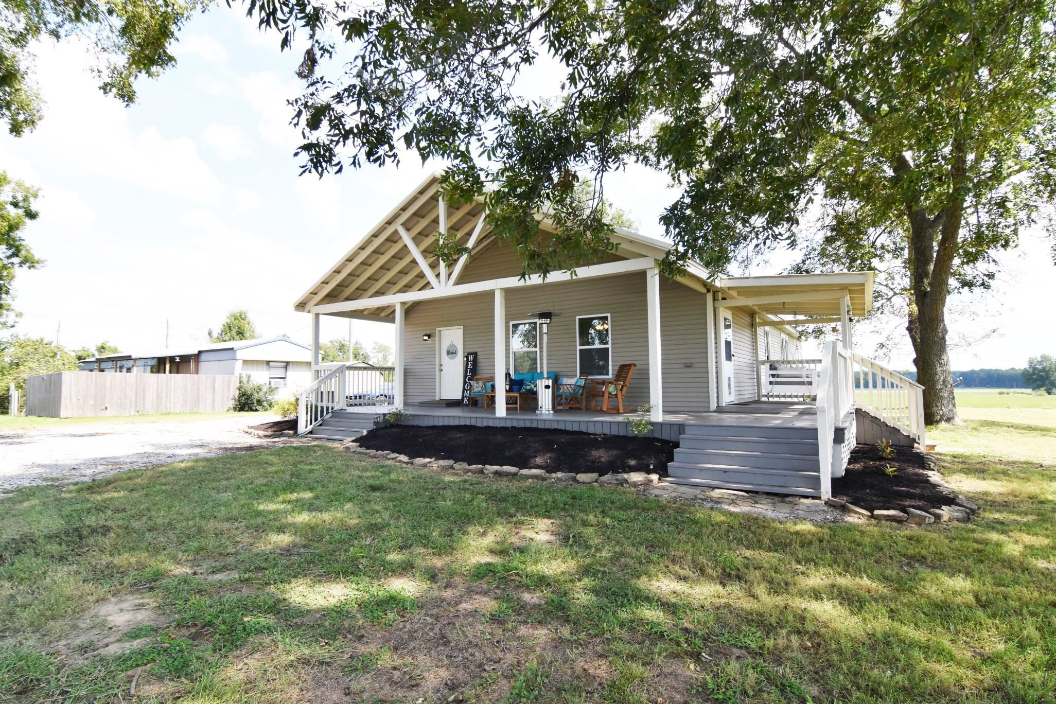 a front view of a house with a yard table and chairs