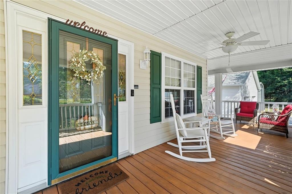 480 Pool Road Hiram, GA 30141 - Photo 17 of 45 a dining room with wooden floor a chandelier a glass table and chairs