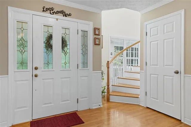 a view of entryway with stairs and wooden floor