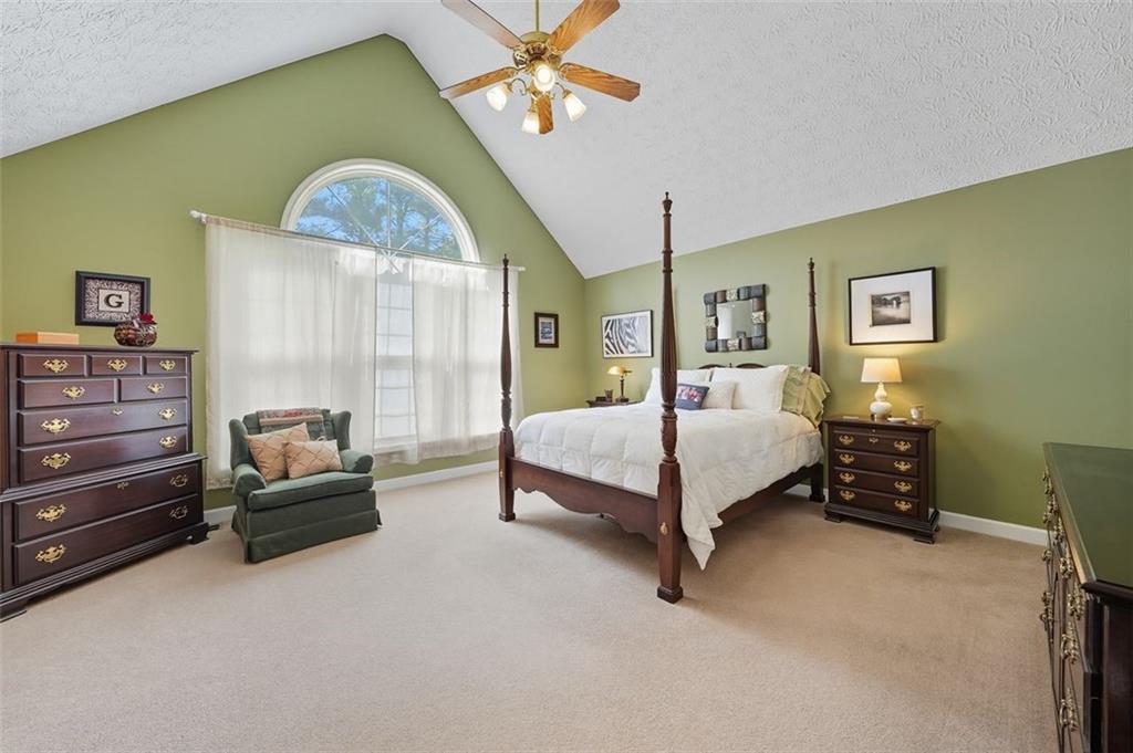 480 Pool Road Hiram, GA 30141 - Photo 30 of 45 a spacious bedroom with a bed and a chandelier