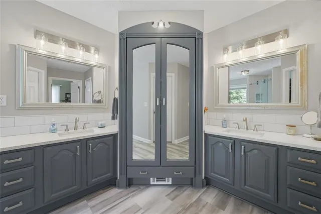 a bathroom with a double vanity sink mirror and