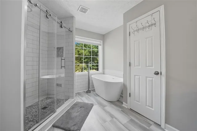 a bathroom with a bathtub shower and toilet