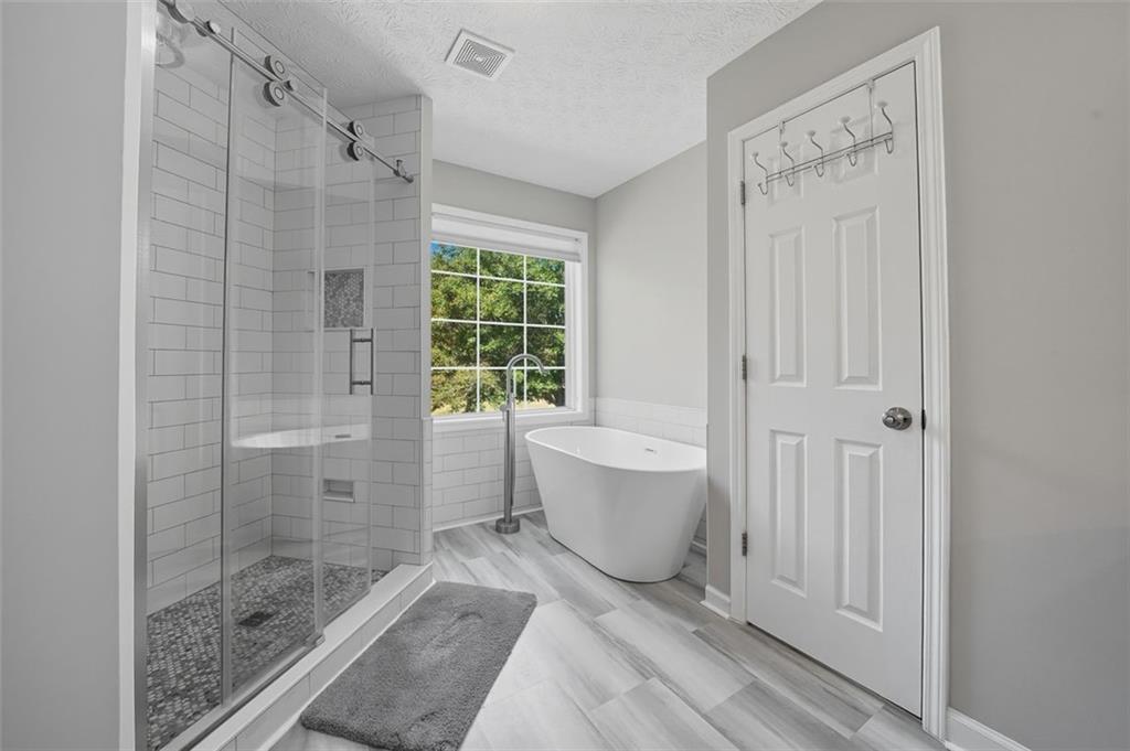 480 Pool Road Hiram, GA 30141 - Photo 33 of 45 a bathroom with a bathtub shower and toilet