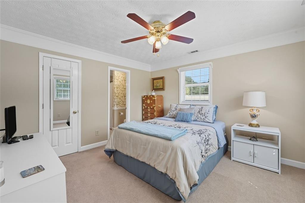 480 Pool Road Hiram, GA 30141 - Photo 36 of 45 a bedroom with a bed and a chandelier