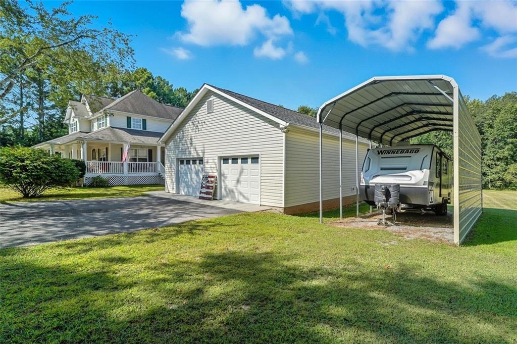 480 Pool Road Hiram, GA 30141 - Photo 7 of 45 a view of a house with a big yard and large trees