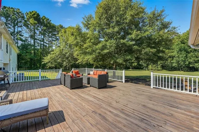 a view of a roof deck with wooden floor and fence