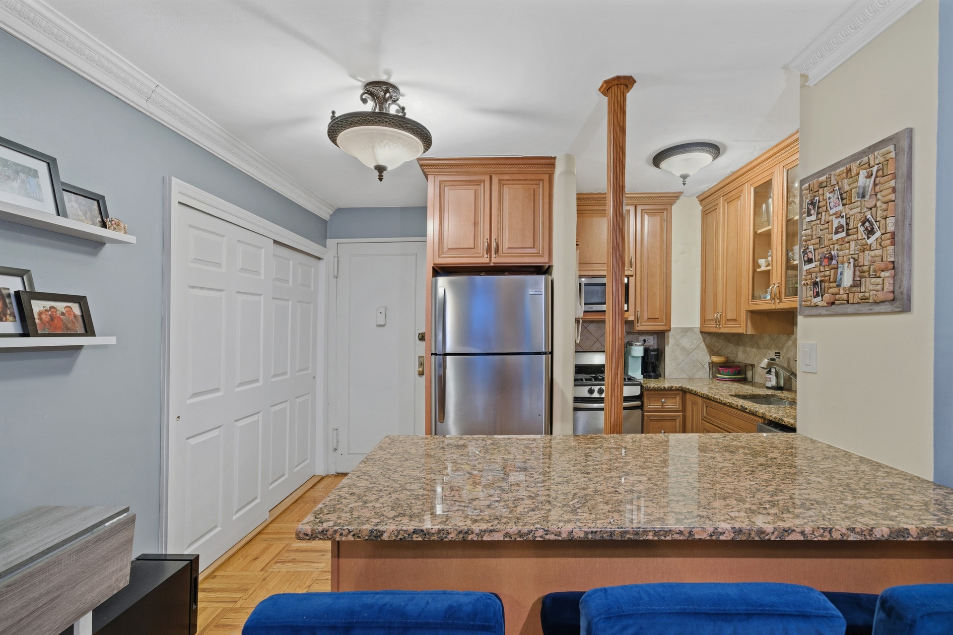 160 East 27th Street, Unit 4F Manhattan, NY 10016 - Photo 4 of 9 a kitchen with kitchen island granite countertop a sink and a refrigerator