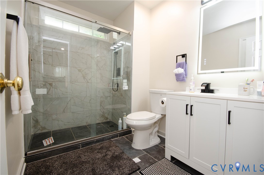 10912 Point Grey Road Henrico, VA 23233 - Photo 4 of 36 Glass-enclosed shower with tiled walls and a dark