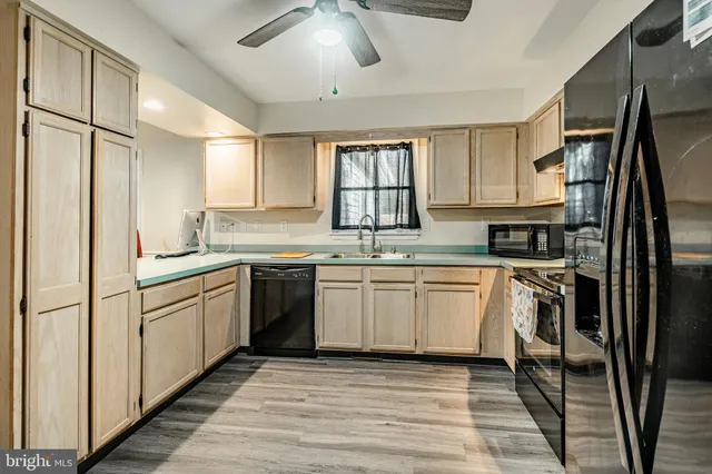 a kitchen with a refrigerator and cabinets