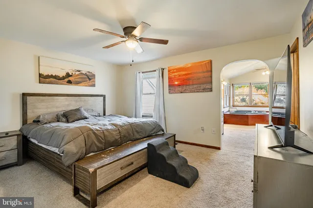 a bedroom with a bed couch and window