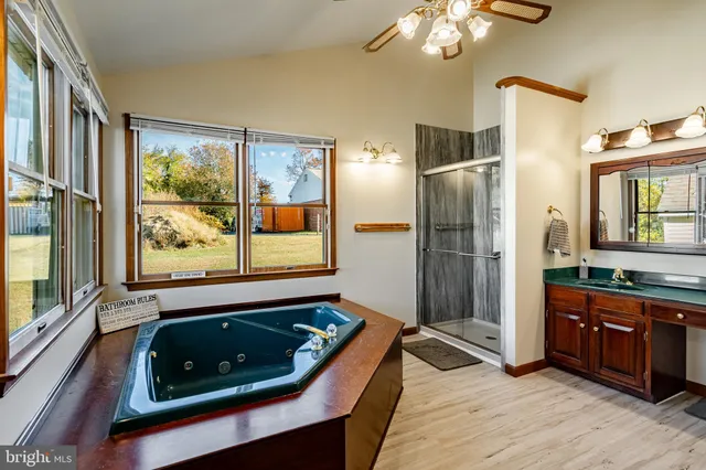 a large spacious bathroom with a tub and shower