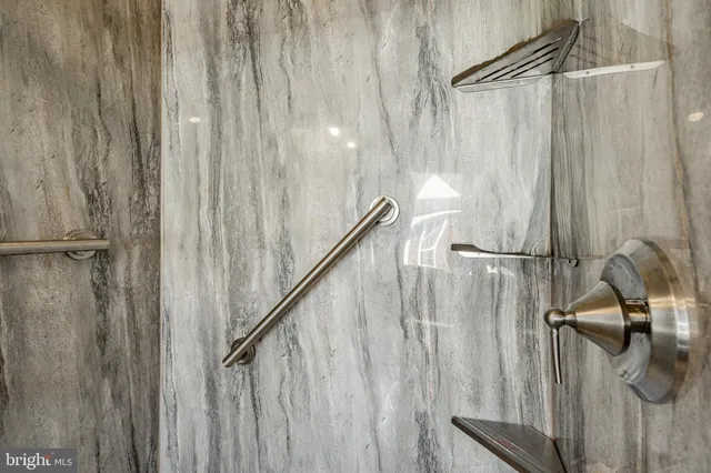 a view of walk in closet with clothes