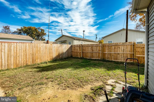 a view of a house with a yard and porch