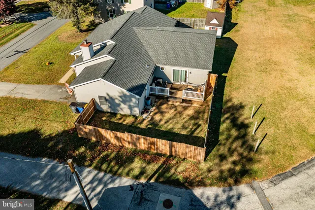 an aerial view of a swimming pool with outdoor seating