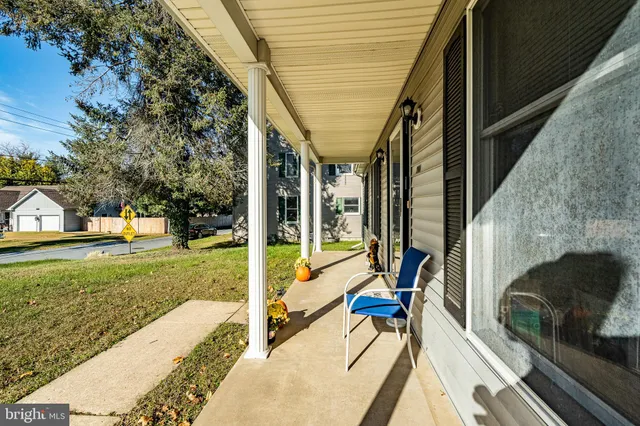 a view of a porch with furniture and a backyard