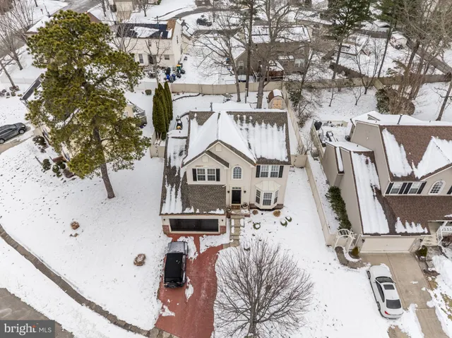 a aerial view of a house with a yard and tree s