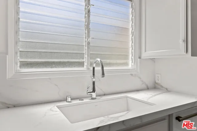 a bathroom with a sink and a window