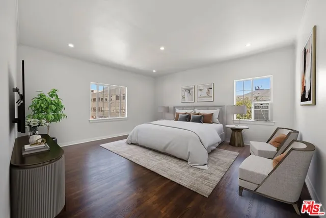 a bedroom with a large bed and a couch