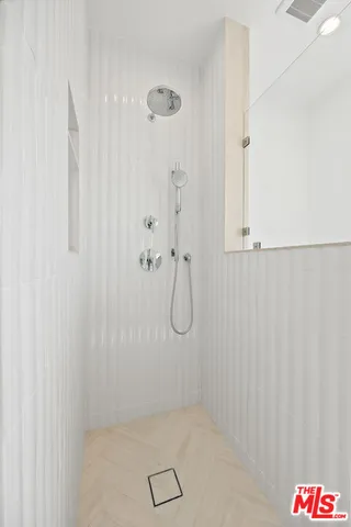 a bathroom with a glass shower door