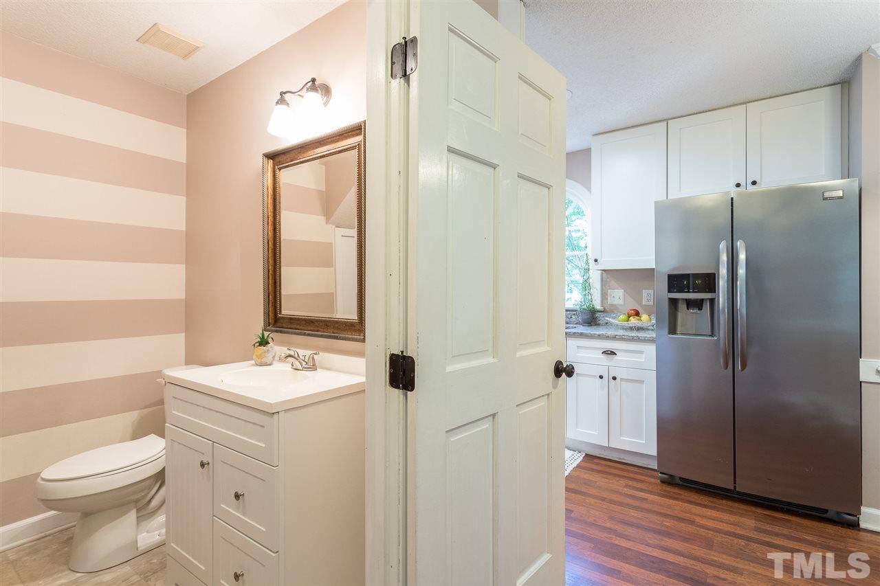 4513 Lancashire Drive Raleigh, NC 27613 - Photo 12 of 25 a bathroom with a double vanity sink toilet and shower