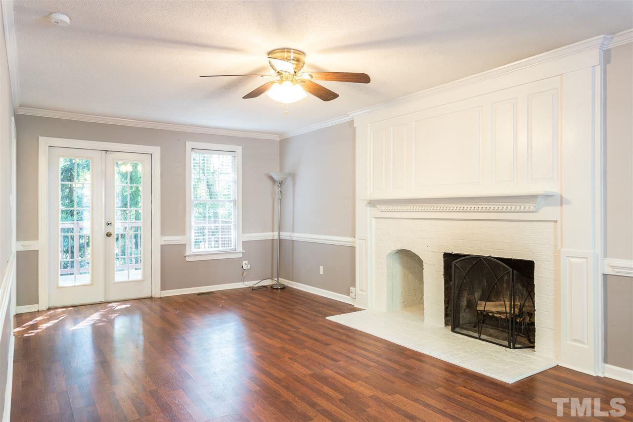 4513 Lancashire Drive Raleigh, NC 27613 - Photo 14 of 25 a view of an empty room with wooden floor and a window