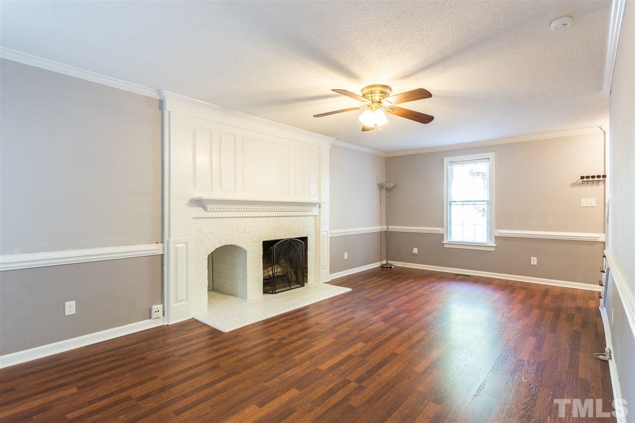 4513 Lancashire Drive Raleigh, NC 27613 - Photo 15 of 25 a view of empty room with wooden floor and fan
