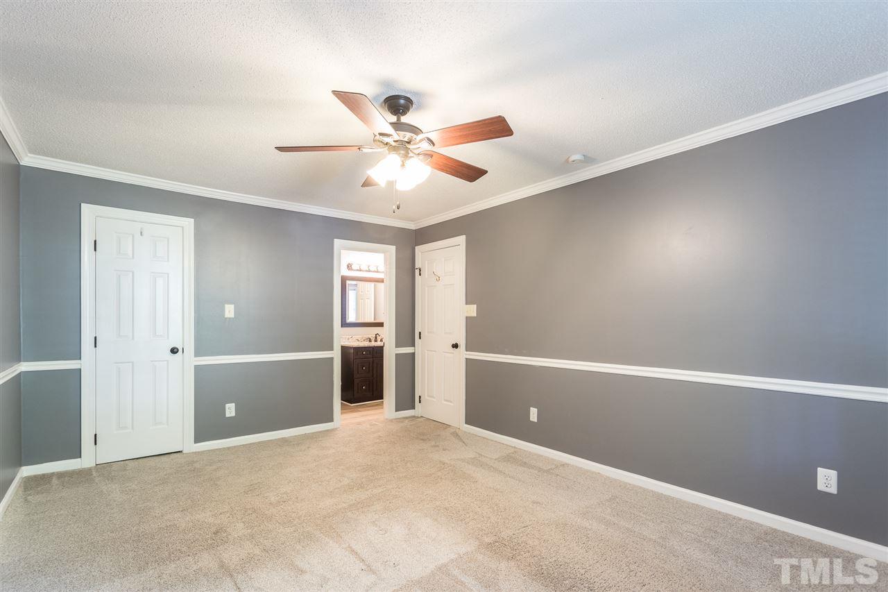 4513 Lancashire Drive Raleigh, NC 27613 - Photo 16 of 25 a view of a livingroom with a ceiling fan and window